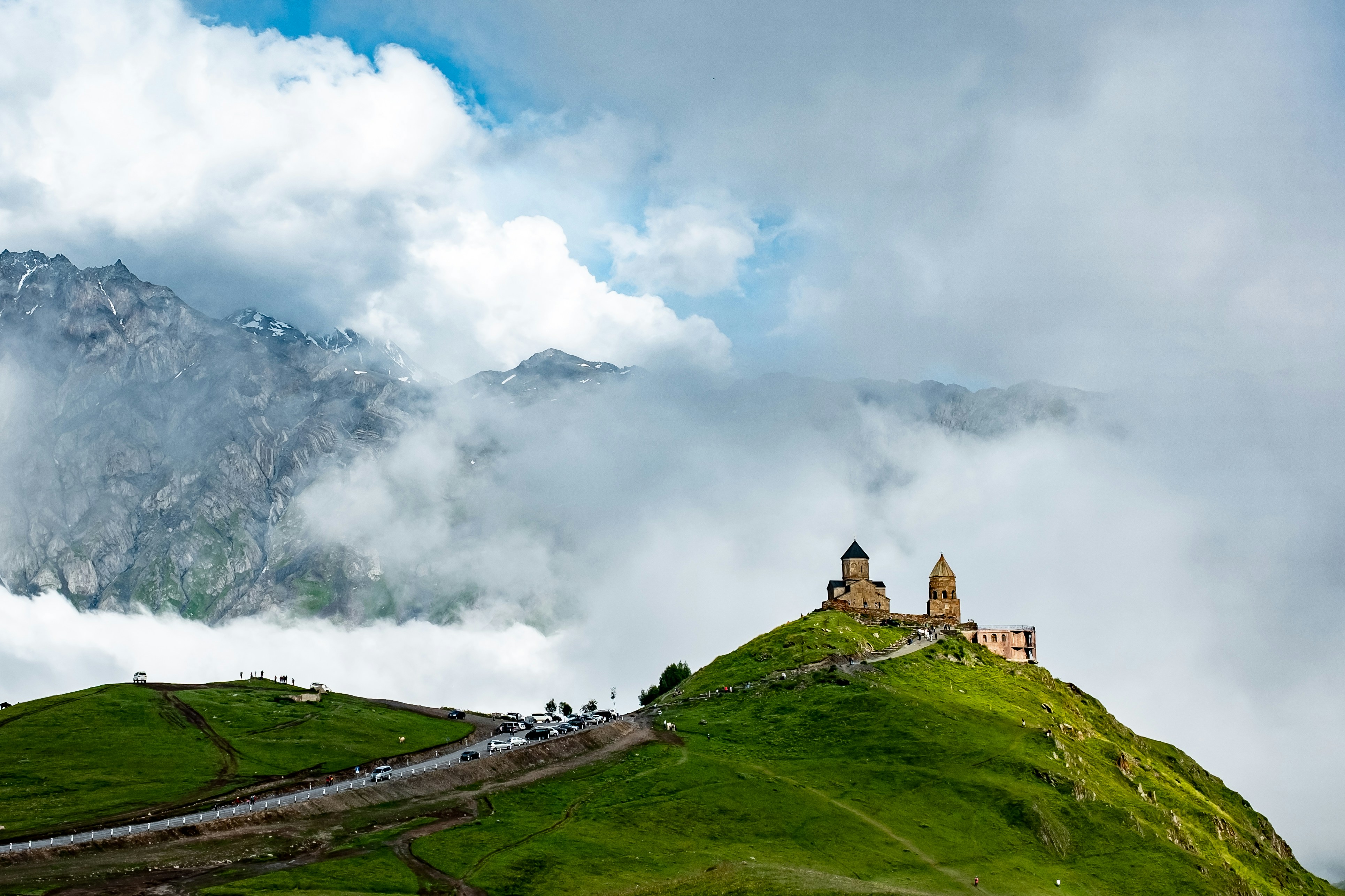Gergeti Trinity against dramatic cliffs
