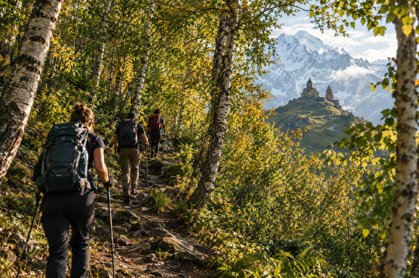 Hikers on the forest trail up to Gergeti Trinity
